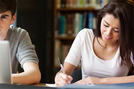 students reading book in classroom teen - Students writing a paper in the library Stock Photo - Budget Royalty-Free & Subscription, Code: 400-05668901