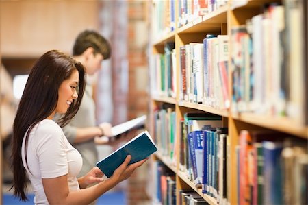 picking up books - Students reading while standing up in a library Stock Photo - Budget Royalty-Free & Subscription, Code: 400-05668955