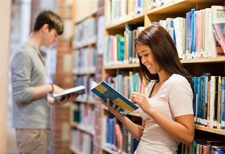 picking up books - Good looking students reading books in a library Stock Photo - Budget Royalty-Free & Subscription, Code: 400-05668964