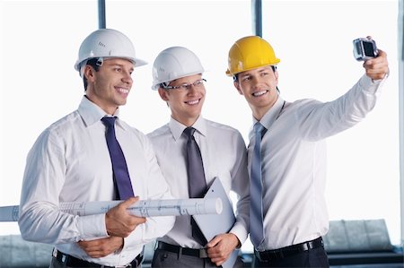 smiling industrial workers group photo - Business people in hard hats are photographed on site Stock Photo - Budget Royalty-Free & Subscription, Code: 400-05669057