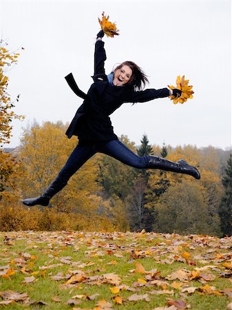 beautiful girl with autumn leafs in a park jumping and smiling Stock Photo - Budget Royalty-Free & Subscription, Code: 400-05669097