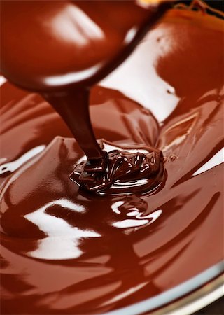 Melted rich dark chocolate dripping from spoon Stock Photo - Budget Royalty-Free & Subscription, Code: 400-05669575