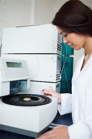 Laboratory assistant using a centrifuge looking away from the camera Fotografie stock - Microstock e Abbonamento, Codice: 400-05669740