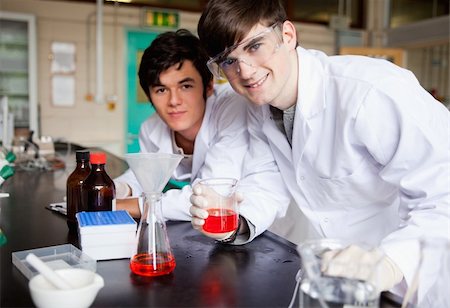 Students showing a red liquid in a laboratory Stock Photo - Budget Royalty-Free & Subscription, Code: 400-05669756