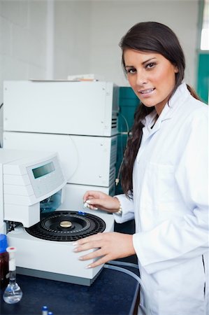 Serious scientist using a centrifuge in a laboratory Fotografie stock - Microstock e Abbonamento, Codice: 400-05669751