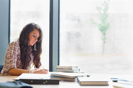 simsearch:400-05678093,k - Beautiful student writing an essay in a library Stock Photo - Budget Royalty-Free & Subscription, Code: 400-05669765