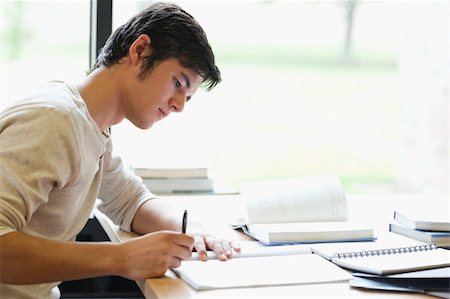 simsearch:400-05678093,k - Serious male student writing in a laboratory Stock Photo - Budget Royalty-Free & Subscription, Code: 400-05669858