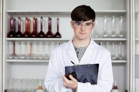 Male science student writing on a clipboard in a laboratory Stock Photo - Budget Royalty-Free & Subscription, Code: 400-05669859