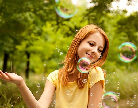 Redhead girl in the park under soap bubble rain. Stock Photo - Budget Royalty-Free & Subscription, Code: 400-05663733