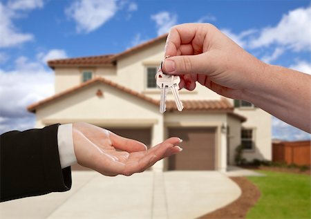 Handing Over the House Keys in Front of a Beautiful New Home. Stock Photo - Budget Royalty-Free & Subscription, Code: 400-05674174