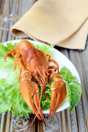 Whole cooked lobster with salad garnish on a plate Stock Photo - Budget Royalty-Free & Subscription, Code: 400-05674403