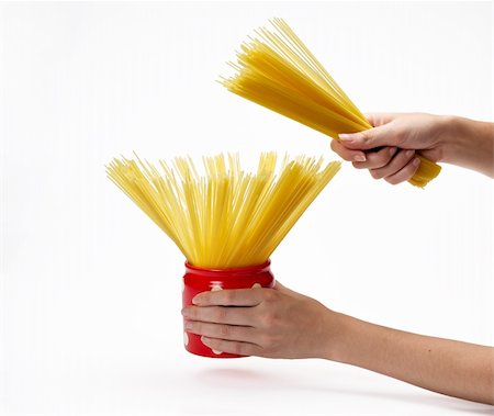 Woman's hands holding red jar full of spaghetti inside.  Isolated on a white background. Fotografie stock - Microstock e Abbonamento, Codice: 400-05674498