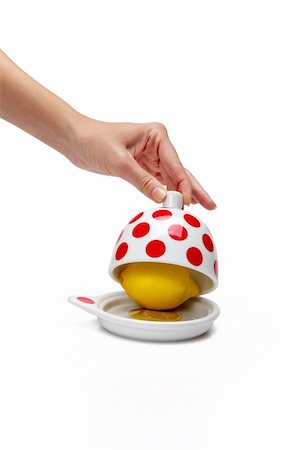 Woman's hand opening bank with lemon inside on a white background Fotografie stock - Microstock e Abbonamento, Codice: 400-05674501