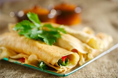 Dessert with the rolled pancakes in a glass plate on the background of canvas cloth Fotografie stock - Microstock e Abbonamento, Codice: 400-05674519