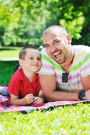 family father and son have fun at park on summer season and representing happiness concept Stock Photo - Budget Royalty-Free & Subscription, Code: 400-05675018