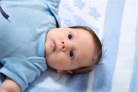 simsearch:400-07088353,k - Portrait of a little baby lying on a bed with blue eyes Foto de stock - Royalty-Free Super Valor e Assinatura, Número: 400-05675058