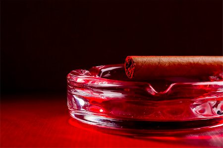 Close-up photograph of a brown cigar on a glass ashtray. Stock Photo - Budget Royalty-Free & Subscription, Code: 400-05675392