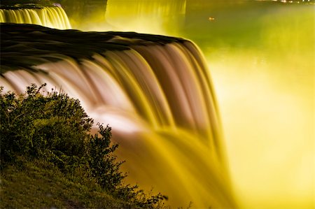 simsearch:400-07919399,k - The American Niagara Falls appear totally covered in yellow light. Photographie de stock - Aubaine LD & Abonnement, Code: 400-05675567