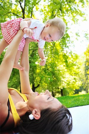 simsearch:400-06062677,k - happy young woman and baby have fun while playing in beautiful bright park at summer season Photographie de stock - Aubaine LD & Abonnement, Code: 400-05676370