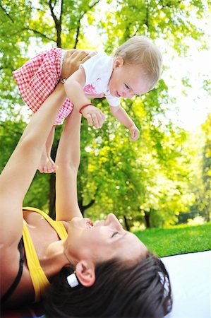 simsearch:400-06062677,k - happy young woman and baby have fun while playing in beautiful bright park at summer season Photographie de stock - Aubaine LD & Abonnement, Code: 400-05676371