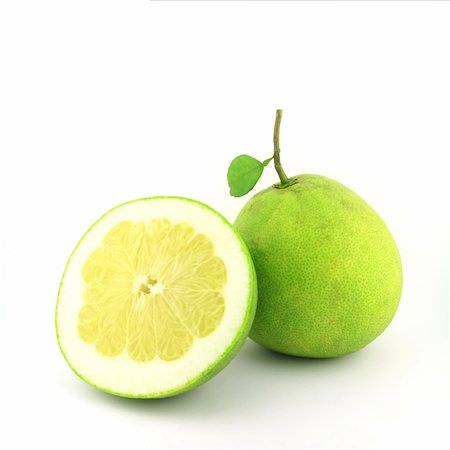 Fresh juicy pomelo with green leafs. Isolated on white background Photographie de stock - Aubaine LD & Abonnement, Code: 400-05676563