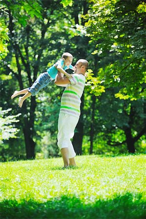 family father and son have fun at park on summer season and representing happiness concept Stock Photo - Budget Royalty-Free & Subscription, Code: 400-05676702