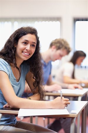 simsearch:400-04035793,k - Portrait of happy young adults writing in a classroom Foto de stock - Super Valor sin royalties y Suscripción, Código: 400-05677795