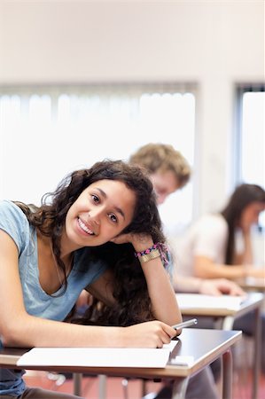 simsearch:400-05677834,k - Portrait of a smiling young student posing in a classroom Photographie de stock - Aubaine LD & Abonnement, Code: 400-05677798