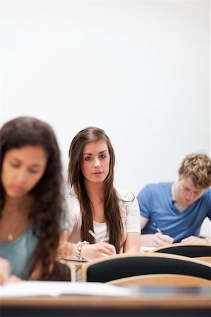 simsearch:400-05677834,k - Young students sitting on a chair in an amphitheater Photographie de stock - Aubaine LD & Abonnement, Code: 400-05677819