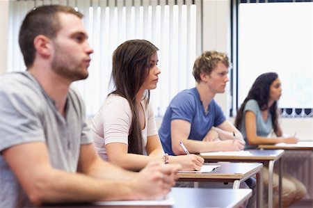 simsearch:400-05677834,k - Studious young adults listening a lecturer in a classroom Photographie de stock - Aubaine LD & Abonnement, Code: 400-05677812