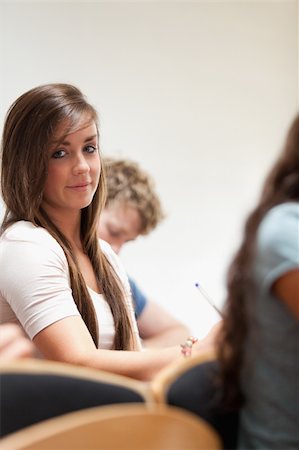 simsearch:400-05684337,k - Portrait of a distracted student sitting in an amphitheater Foto de stock - Royalty-Free Super Valor e Assinatura, Número: 400-05677825