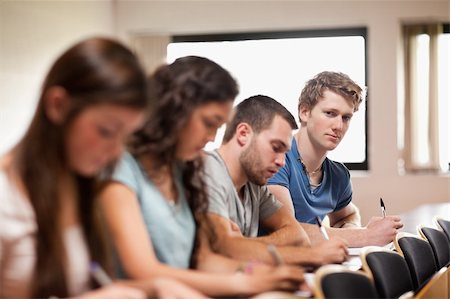 simsearch:400-05684360,k - Students listening a lecturer with the camera focus on the foreground in an amphitheater Stock Photo - Budget Royalty-Free & Subscription, Code: 400-05677839