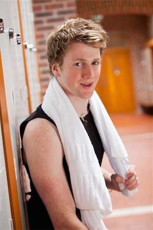 simsearch:400-04256139,k - Portrait of a sports student leaning on a locker with a towel Stock Photo - Budget Royalty-Free & Subscription, Code: 400-05677930