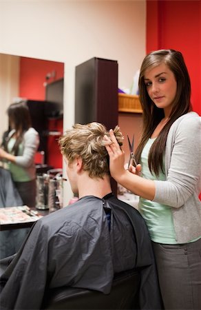 simsearch:400-05677974,k - Portrait of a young woman cutting a man's hair with scissors Foto de stock - Super Valor sin royalties y Suscripción, Código: 400-05678017
