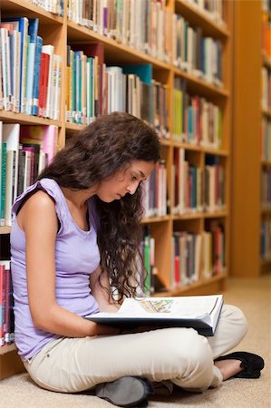 simsearch:400-05678093,k - Portrait of a serious student reading a book in a library Stock Photo - Budget Royalty-Free & Subscription, Code: 400-05678025