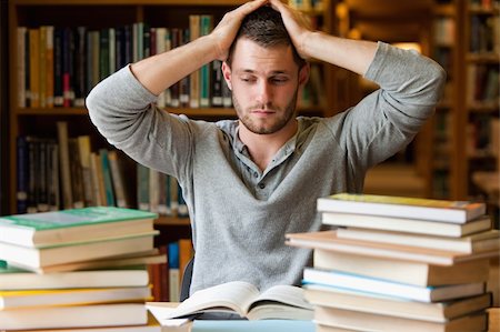 stressed college - Tired student having too much to do in a library Stock Photo - Budget Royalty-Free & Subscription, Code: 400-05678147