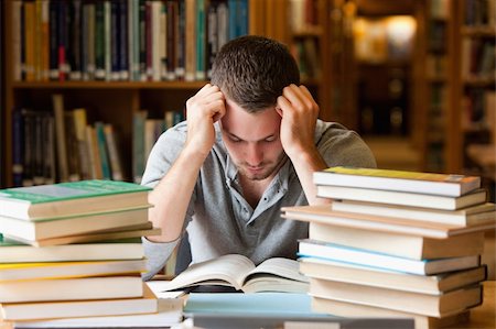 stressed college - Tired student having a lot to read in a library Stock Photo - Budget Royalty-Free & Subscription, Code: 400-05678148