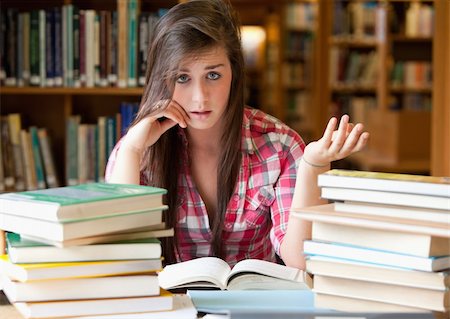 simsearch:400-05678149,k - Disappointed student having a lot to read in a library Stockbilder - Microstock & Abonnement, Bildnummer: 400-05678154