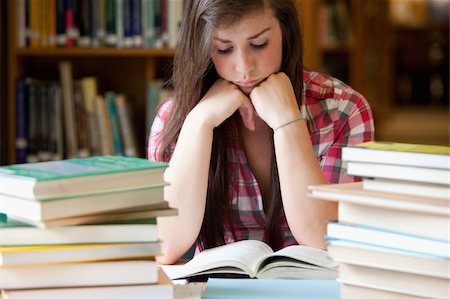 simsearch:400-05678149,k - Studious woman surrounded by books in a library Stockbilder - Microstock & Abonnement, Bildnummer: 400-05678153