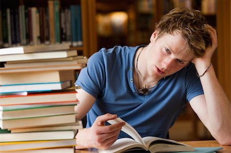 stressed student - Tired man with a book in a library Stock Photo - Budget Royalty-Free & Subscription, Code: 400-05678170