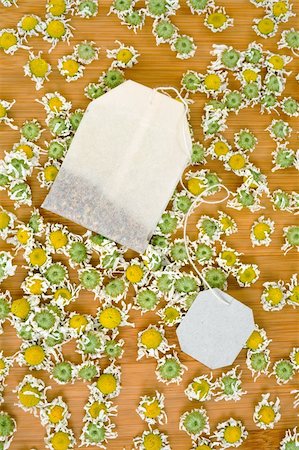 simsearch:400-05713050,k - Bag of chamomile tea with dry chamomilla flowers over wooden background Stock Photo - Budget Royalty-Free & Subscription, Code: 400-05678542