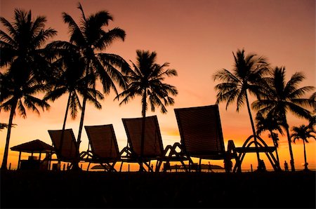 simsearch:400-06947087,k - Row deckchairs on beach at sunset, Tanjung Aru, Malaysia. Stock Photo - Budget Royalty-Free & Subscription, Code: 400-05679223