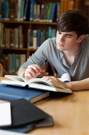 simsearch:400-05678093,k - Portrait of a handsome student writing a paper in a library Stock Photo - Budget Royalty-Free & Subscription, Code: 400-05670008