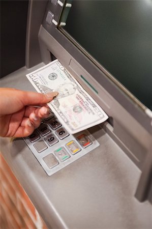 Portrait of a feminine hand withdrawing dollars at an ATM Fotografie stock - Microstock e Abbonamento, Codice: 400-05670028