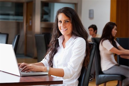 Young woman using a laptop in a cafe Stock Photo - Budget Royalty-Free & Subscription, Code: 400-05670091