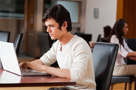 simsearch:400-03996848,k - Handsome man using a notebook in a cafe Fotografie stock - Microstock e Abbonamento, Codice: 400-05670104