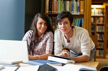 simsearch:400-05668910,k - Good looking students working together in the library Stock Photo - Budget Royalty-Free & Subscription, Code: 400-05670285