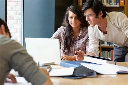 students reading book in classroom teen - Smiling students working together in the library Stock Photo - Budget Royalty-Free & Subscription, Code: 400-05670283