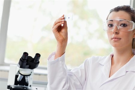 simsearch:400-05670478,k - Beautiful science student holding a microscope slide in a laboratory Stock Photo - Budget Royalty-Free & Subscription, Code: 400-05670491