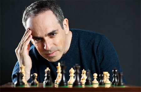 Chessboard with man thinking about chess strategy Stock Photo - Budget Royalty-Free & Subscription, Code: 400-05670548